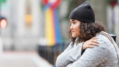 Teenager with hat looking into distance
