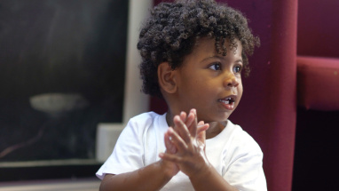 Young boy clapping