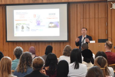Man presenting in front of an audience