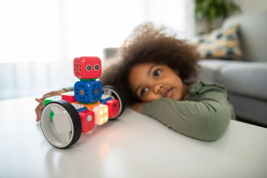 Child looking hopefully at robot toy