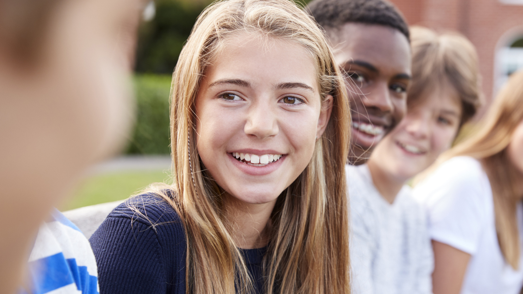 A group of young people sitting together.