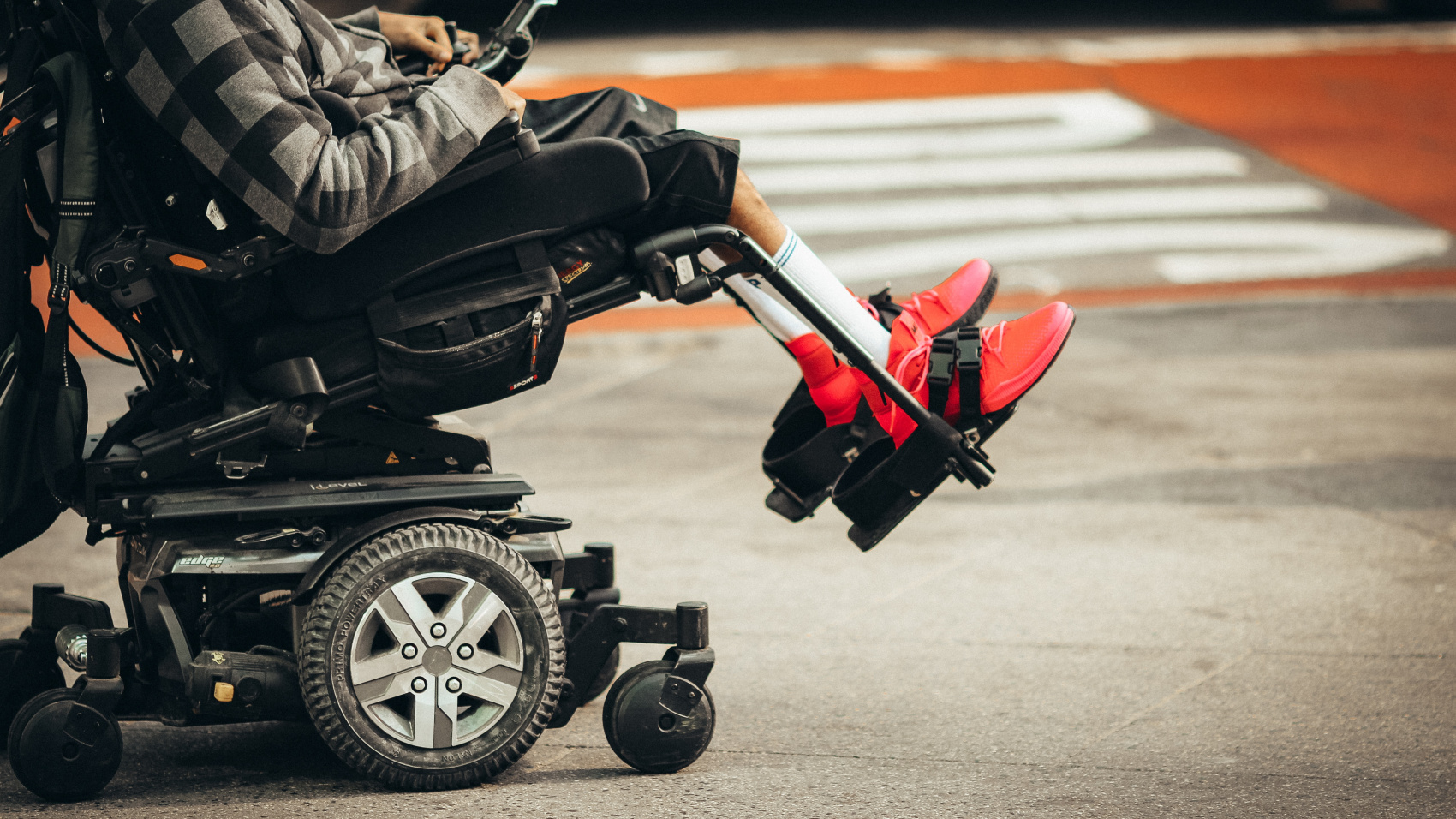 A wheelchair user crosses the road