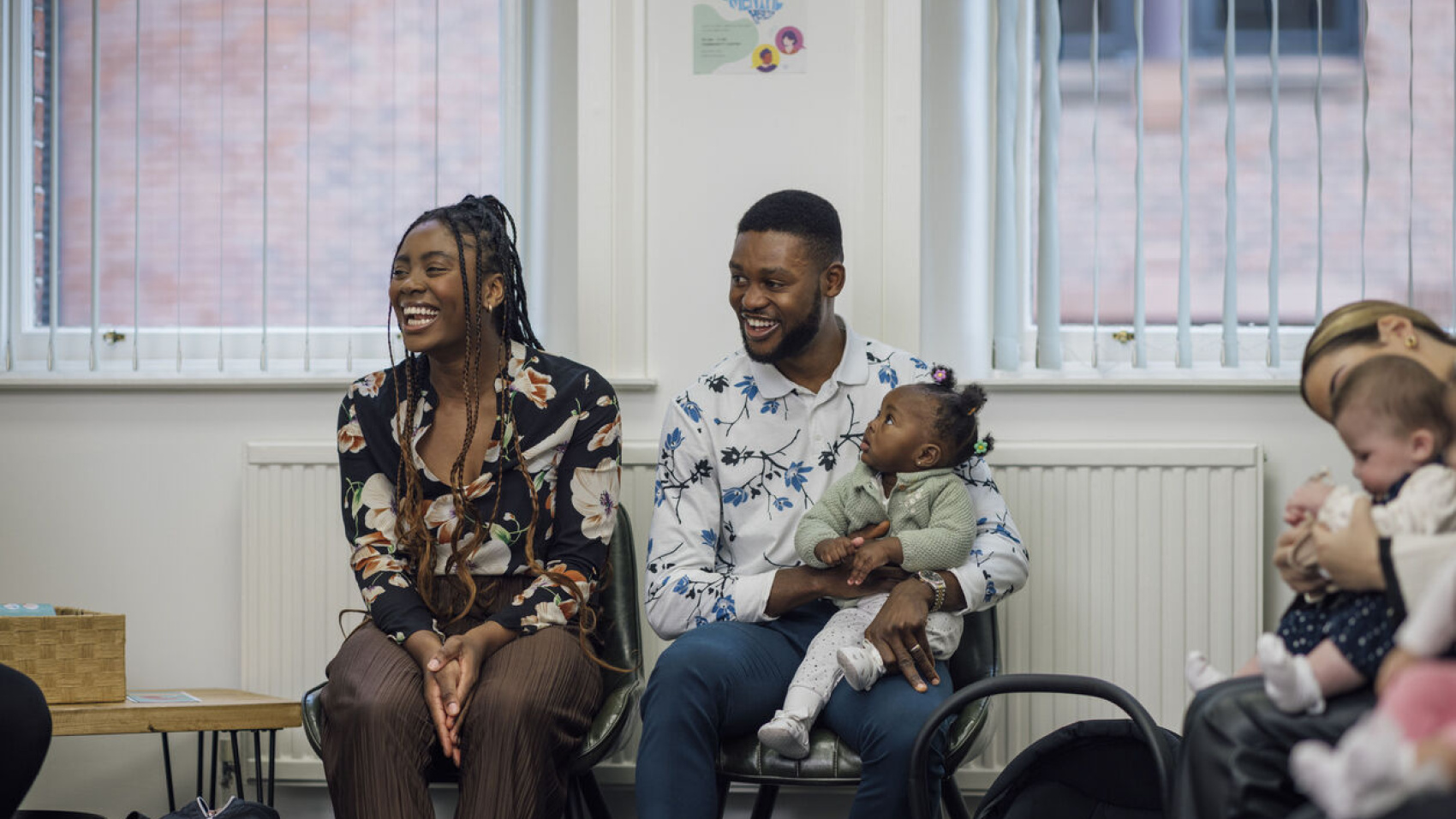 Mother, father and baby in a waiting room