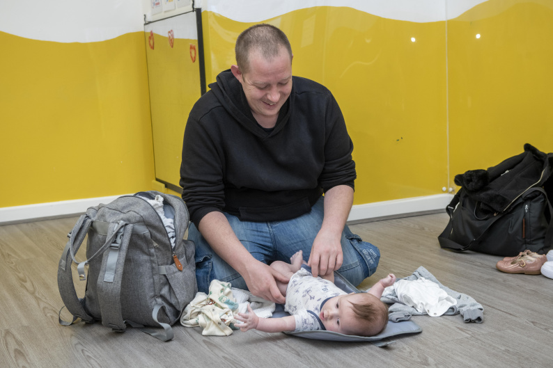 Man changing baby's nappy