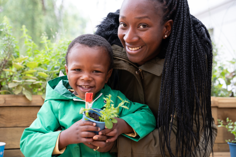 A woman and child smiling in the garden