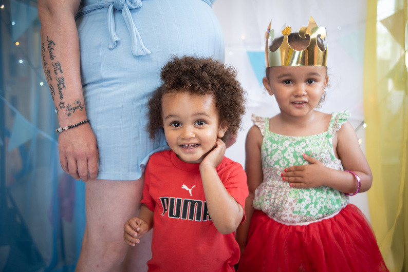 Two early years children smiling at camera