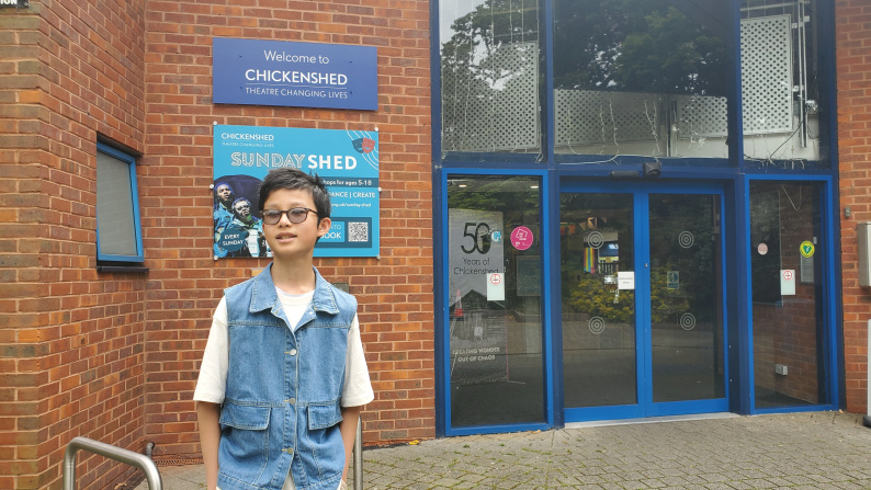 Chapman standing outside Chickenshed Theatre