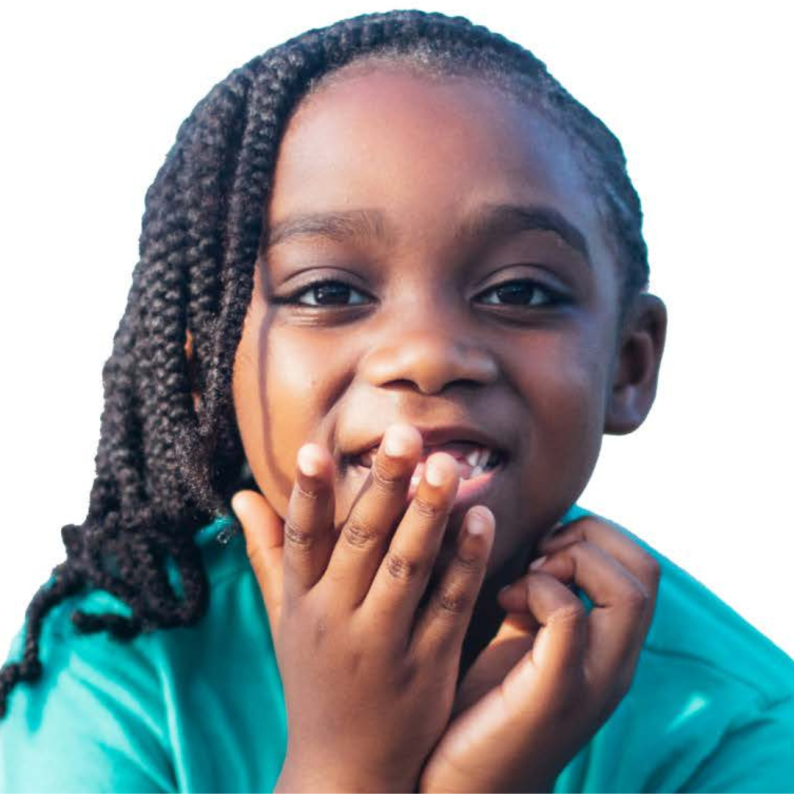 Child smiling with hand over face