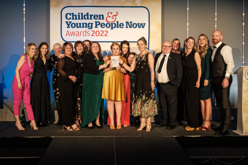 The CDC and Rochdale team with the award in front of CYP Now sign at the awards ceremony