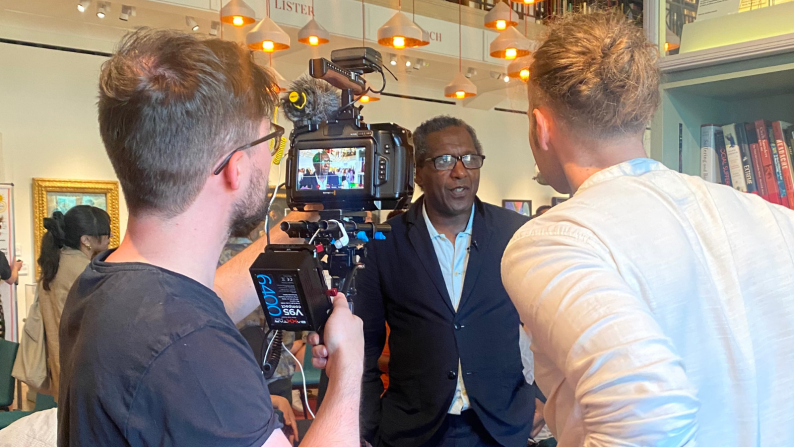 Lemn Sissay speaking to a camera crew
