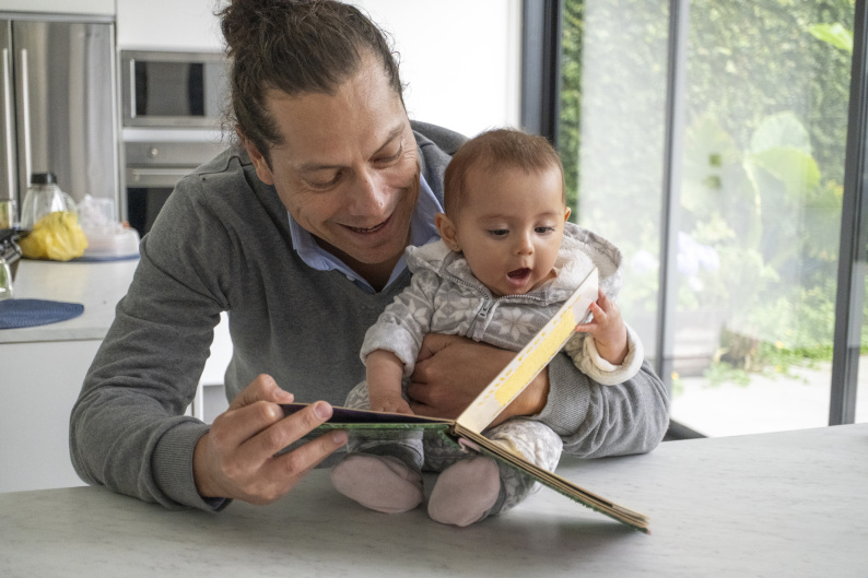 Father reading with his baby